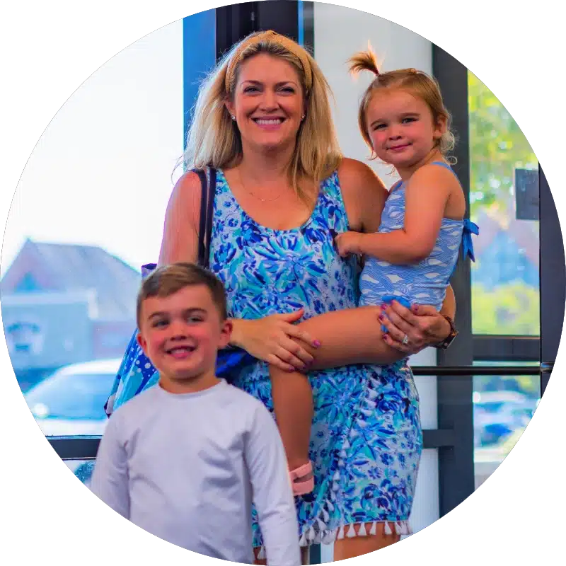 Smiling family with a mom, son, and young daughter in a Big Blue facility