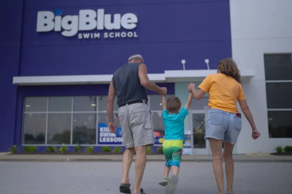 a family walking into a Big Blue storefront